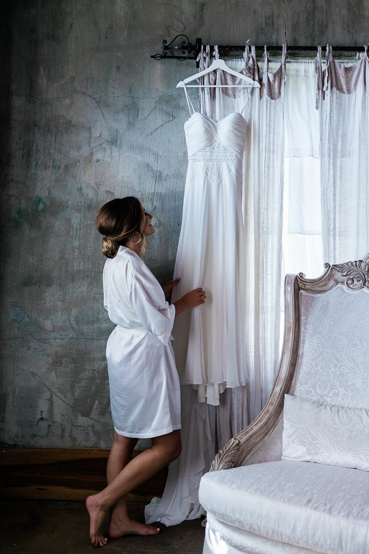 Bride hanging her dress in the bridal suite while getting ready for her wedding at Olde Dobbin Station.