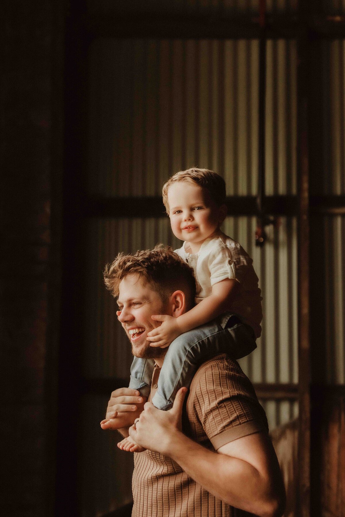 Child sitting on the shoulders of her dad Sydney Petite Session Family Studio Shoot