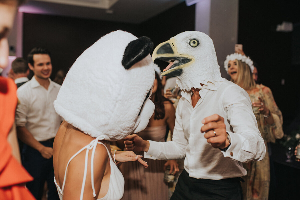 Bride and groom wearing animal head costumes at a Colorado wedding