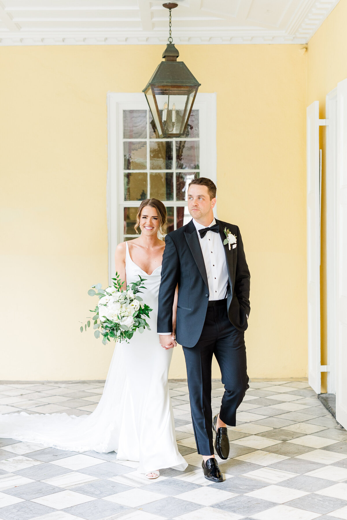 bride and groom walking at their wedding in downtown Charleston