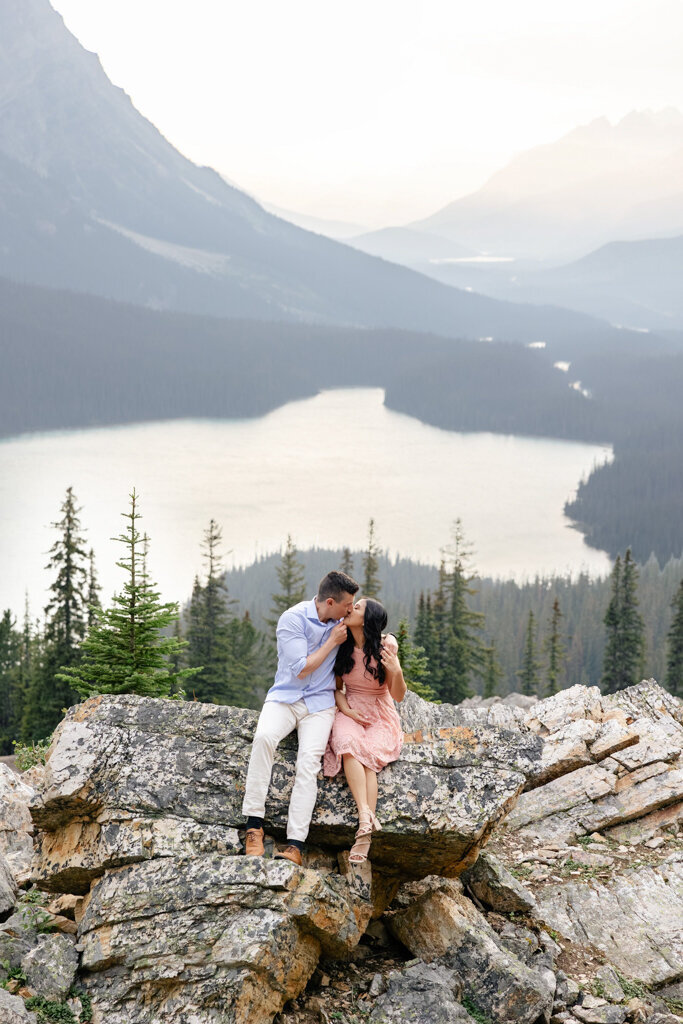 Romantic couple enjoying a scenic mountain view with lake in background, captured by Lorissa Lee Photography. Featured on Brontë Bride.