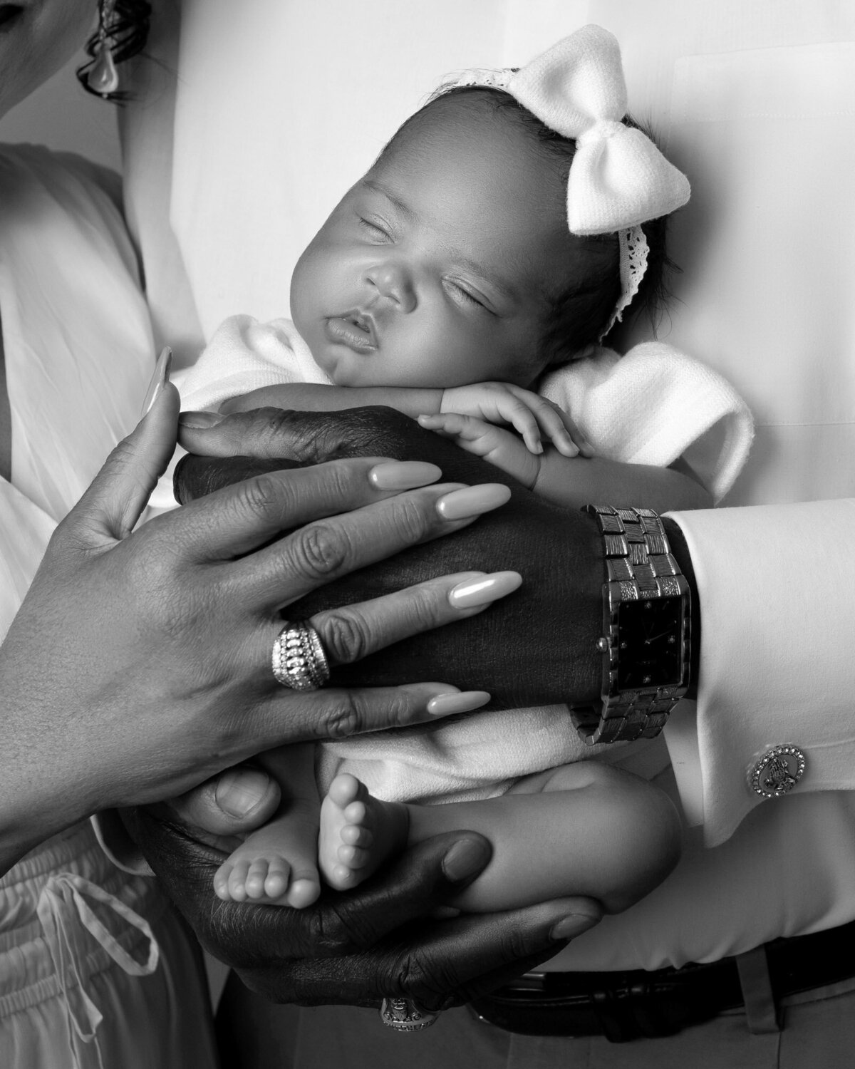 Black white father hands holding newborn Westlake artistic family photographer