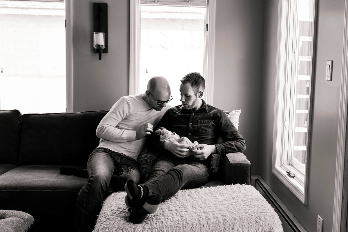 NJ Newborn photos of two dads gazing at their baby