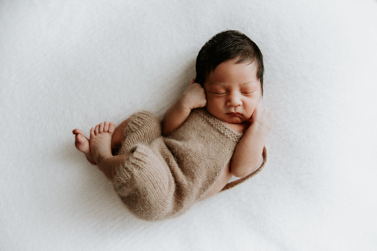 Melbourne newborn photography session shot at a clients home captures 10 day old newborn sleeping.
