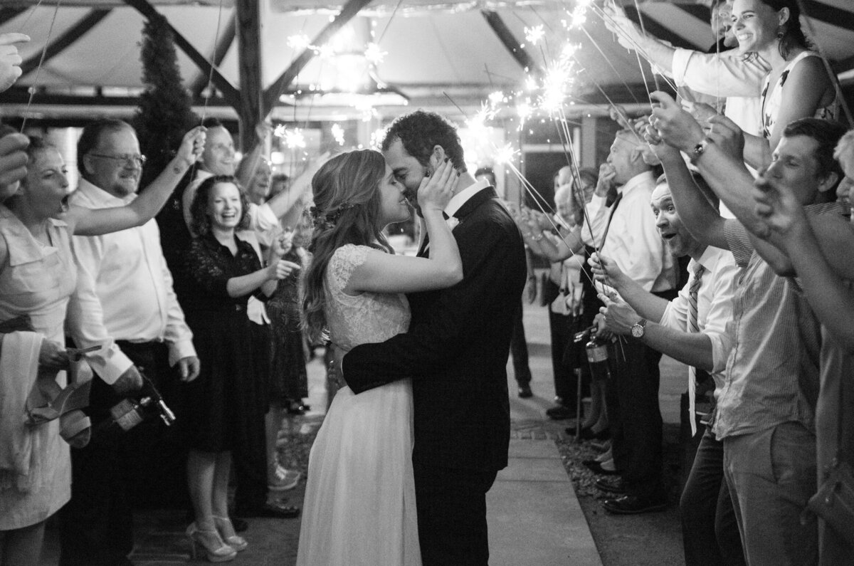 Montana bride and groom kiss while guests celebrate