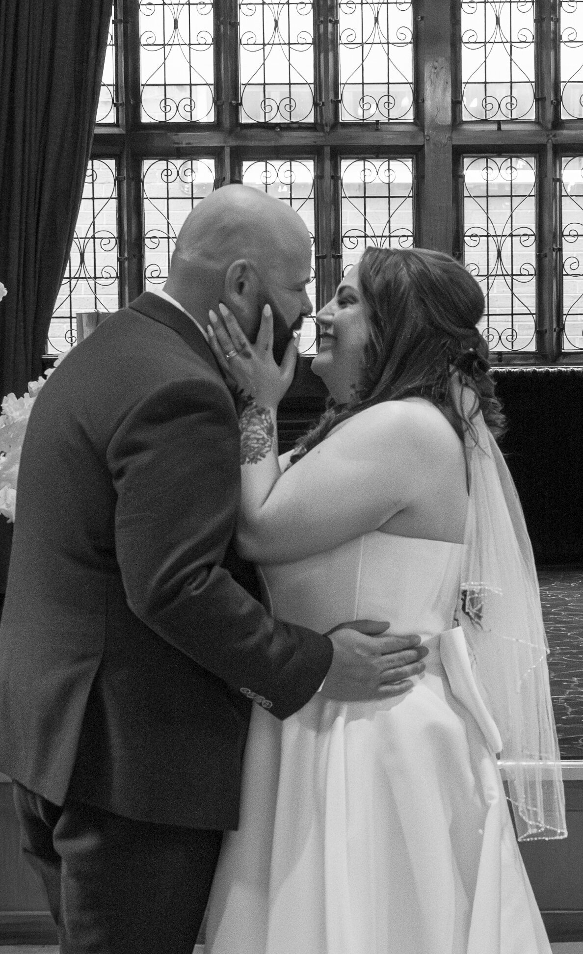 Bride and groom's first kiss during ceremony at Worsley Court House Manchester wedding photographer