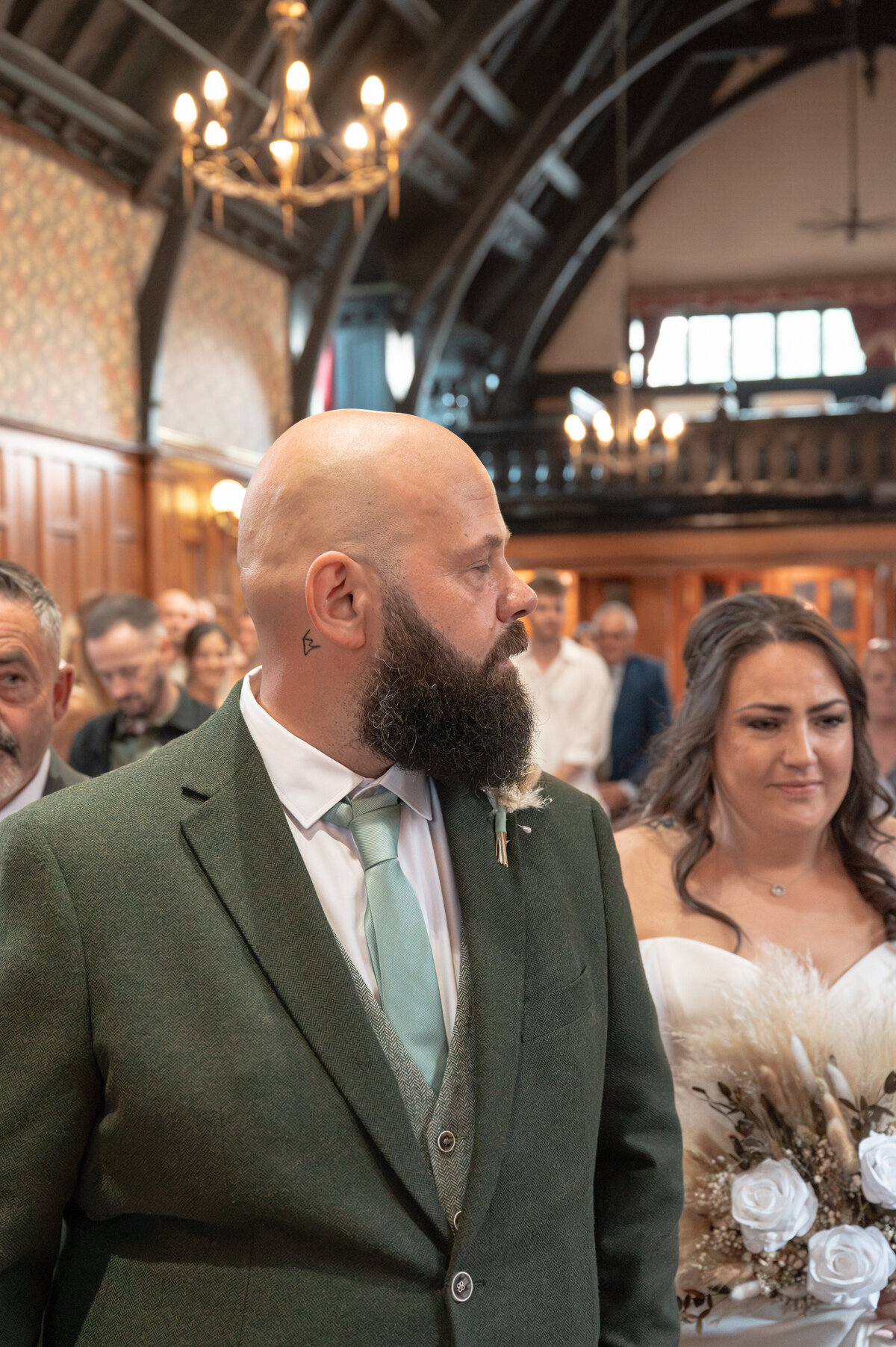 Bride walking down the aisle and groom's reaction during wedding ceremony at Worsley Court House, Manchester wedding photographer