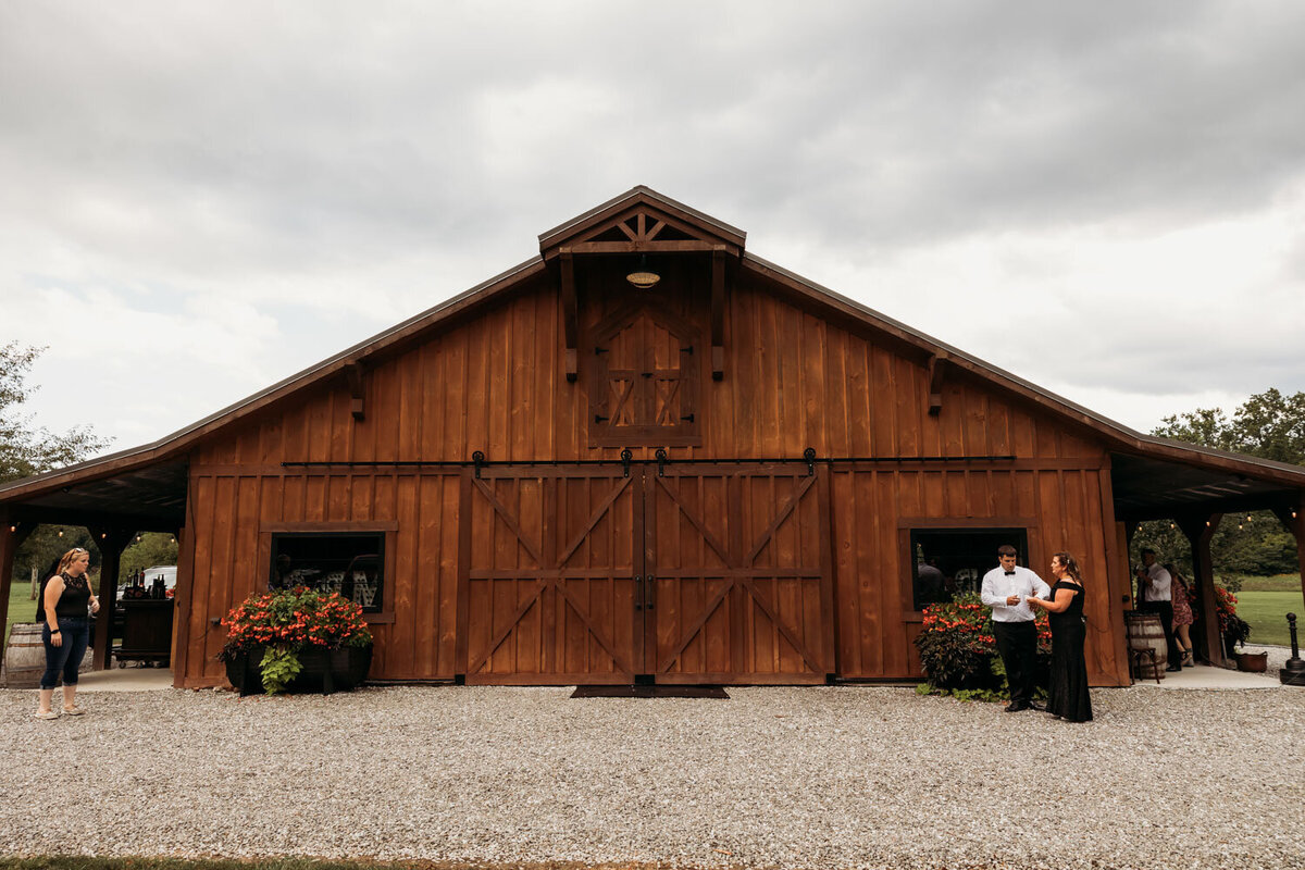Rustic barn exterior with guests nearby