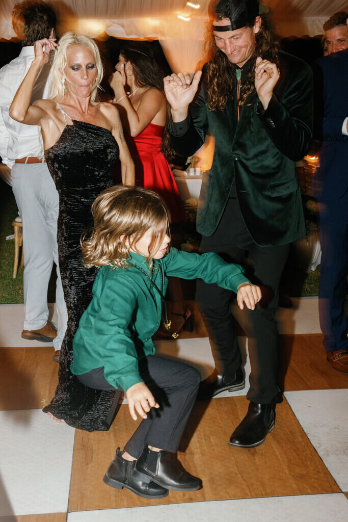 The groom's friends bring high energy to the dance floor, enjoying a night of celebration and laughter. Florida Keys wedding photography by Claudia Amalia Photography.