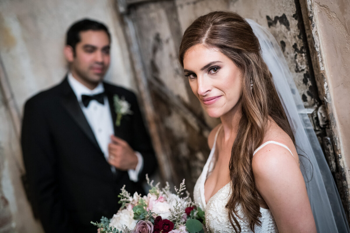 Bride with groom in the background