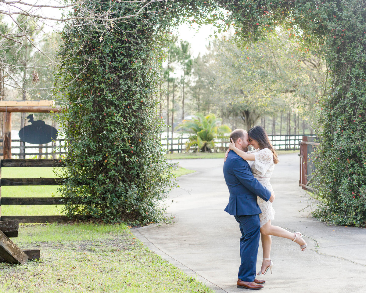Couples/engagement guy lifting girl by Lucas Mason Photography in Orlando