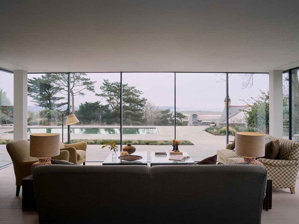 Wide angle view of sitting room with pool outside