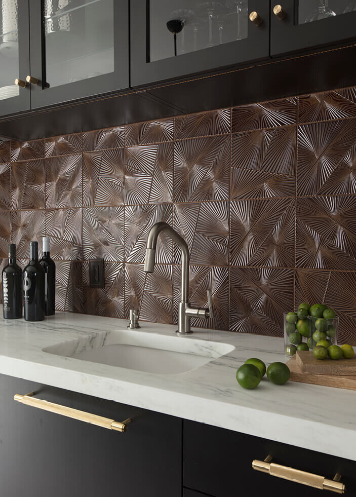 Boston Kitchen Designer uses Kelly Wearstler tile from Ann Sacks, marble counters, dark grey cabinets, and brass hardware in a Westwood renovation project.