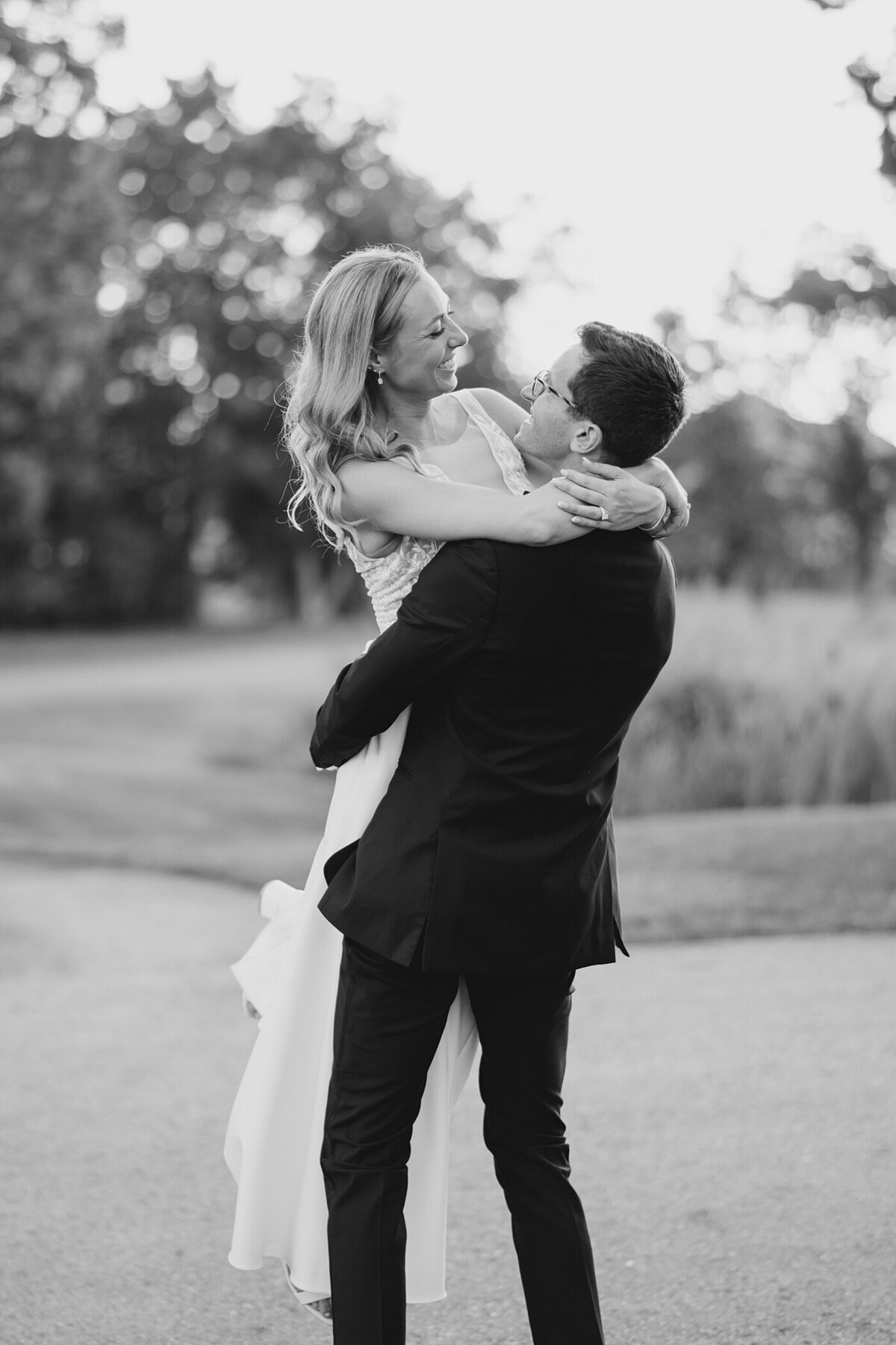 groom picks up his bride and twirls her around captured by Columbus wedding  photographer