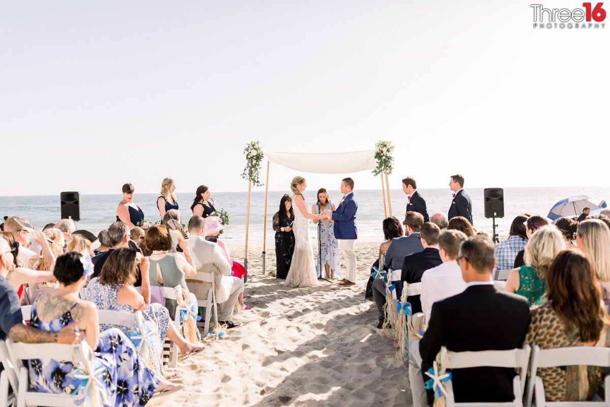 Bride and Groom celebrate a Jewish wedding service at the beach