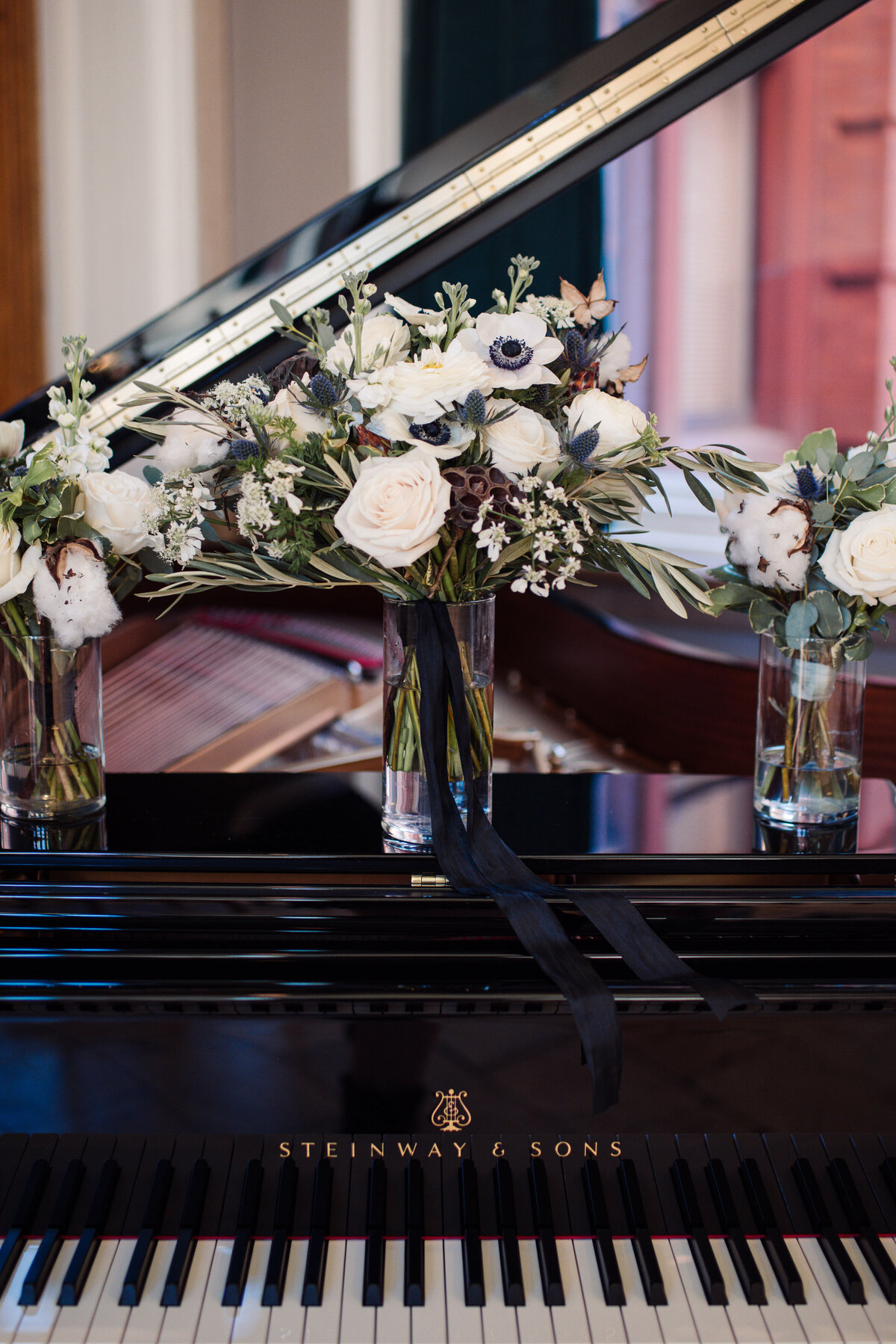 black and white wedding with flowers by haven floral compnay on top of steinway piano in MA