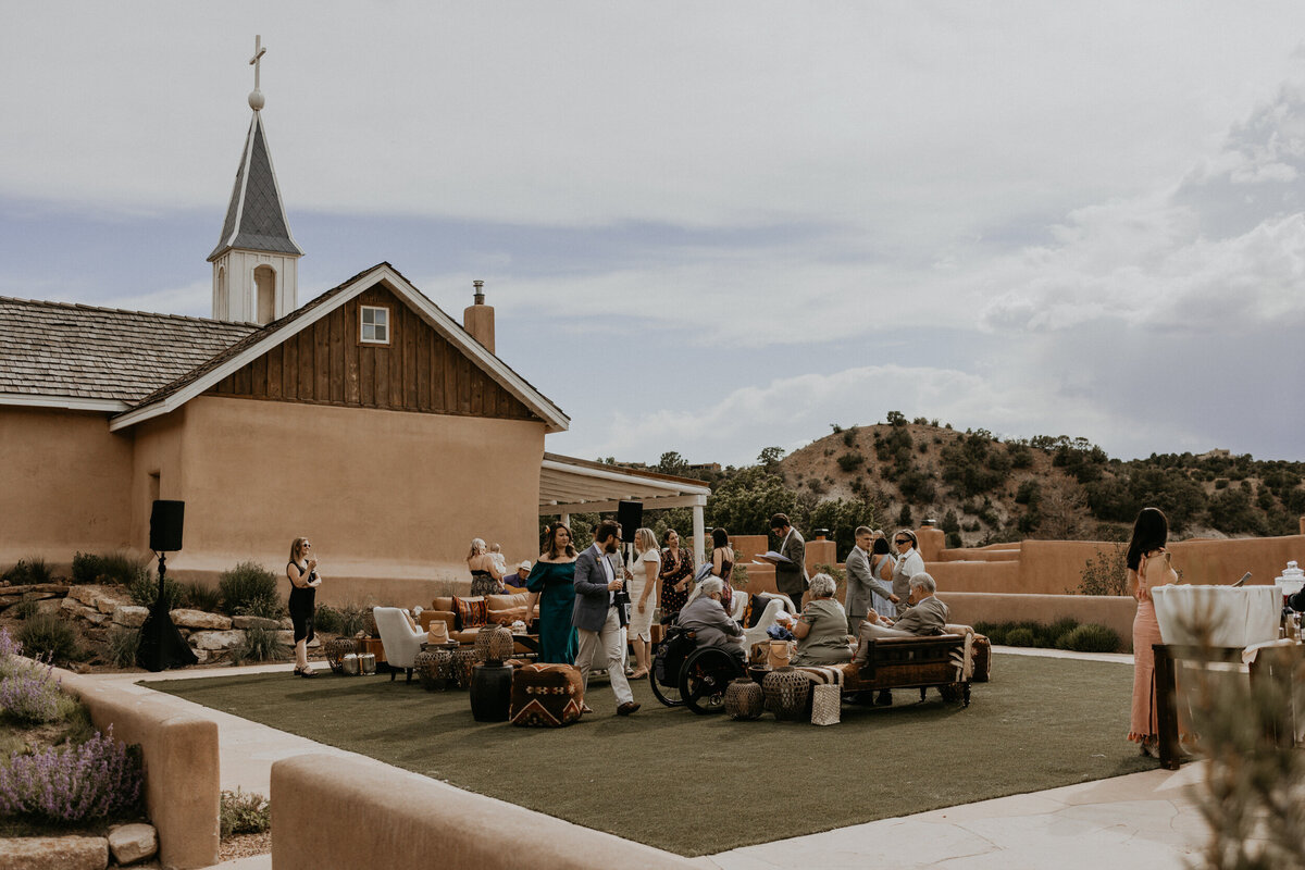wide view of guests mingling outside of the the chapel at Bishop's Lodge Santa Fe