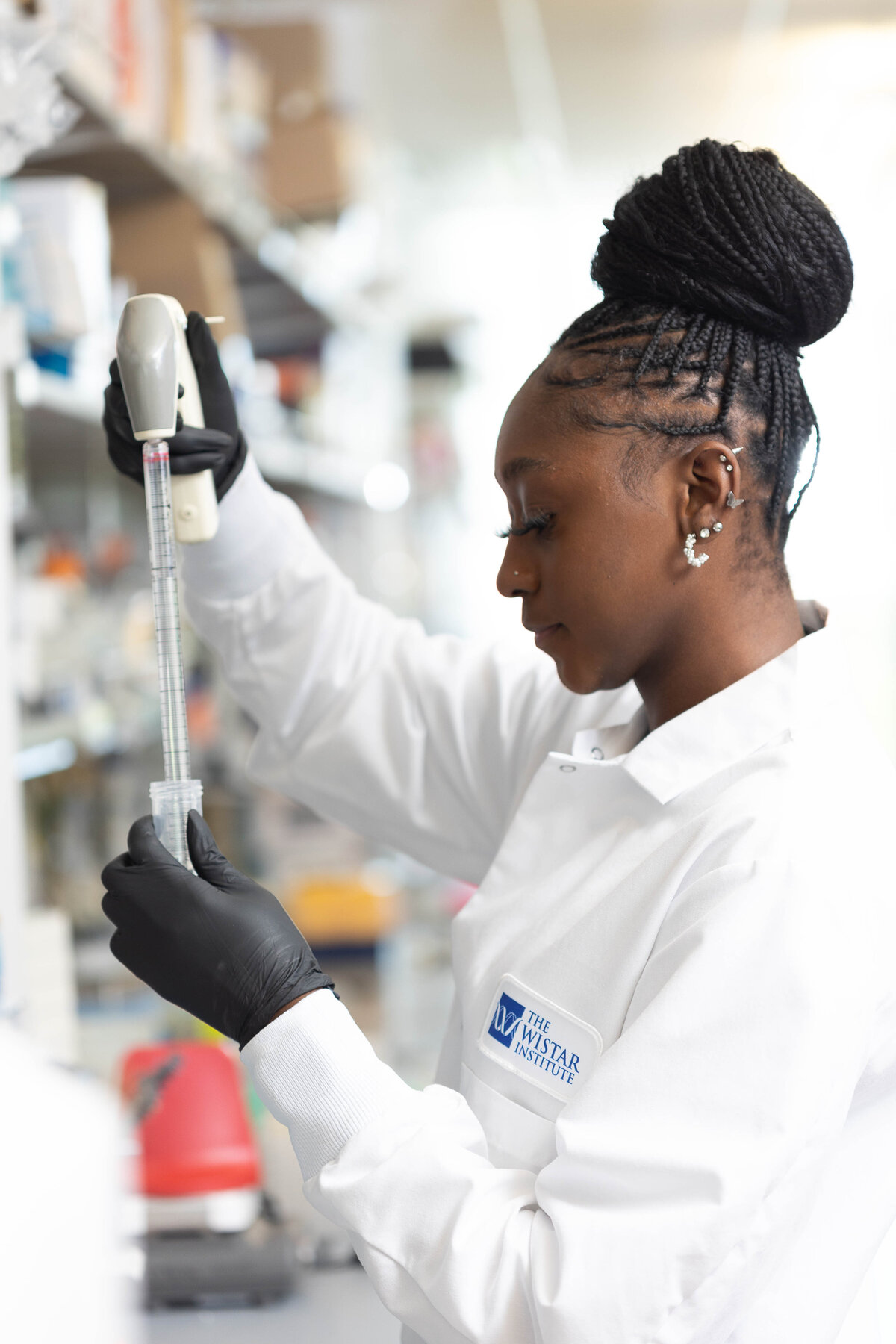 Female scientist pipetting into a test tube