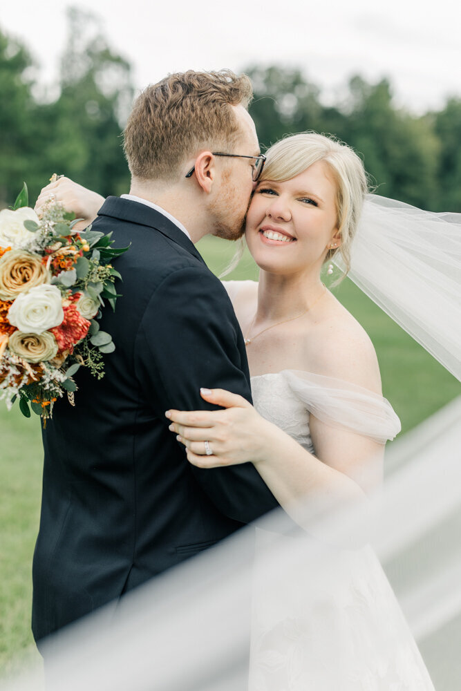 Bride and groom with long veil