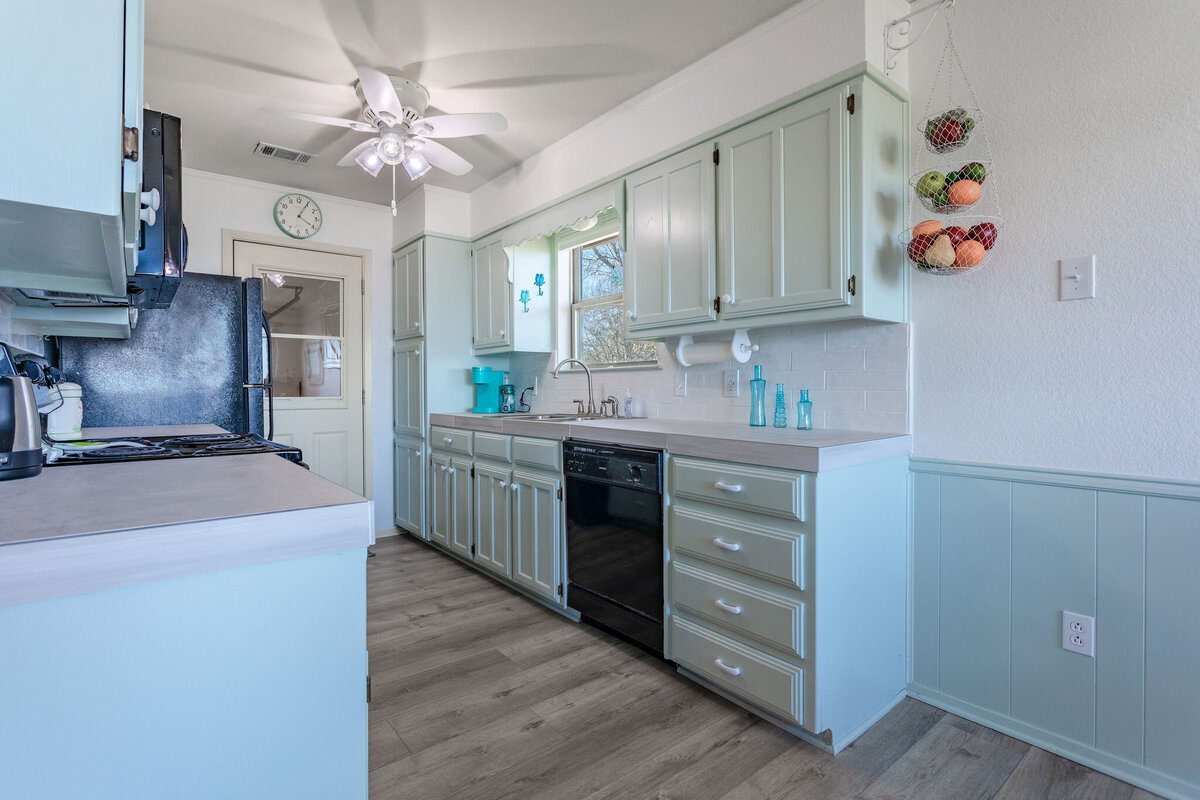 Fully equipped kitchen with plenty of counter space in this 2-bedroom, 2-bathroom lakeside vacation rental home for 6 guests on Tradinghouse Lake with privacy access to a fishing dock and boat launch pad, ping pong table, gazebo, free wifi and free parking in Waco, TX.
