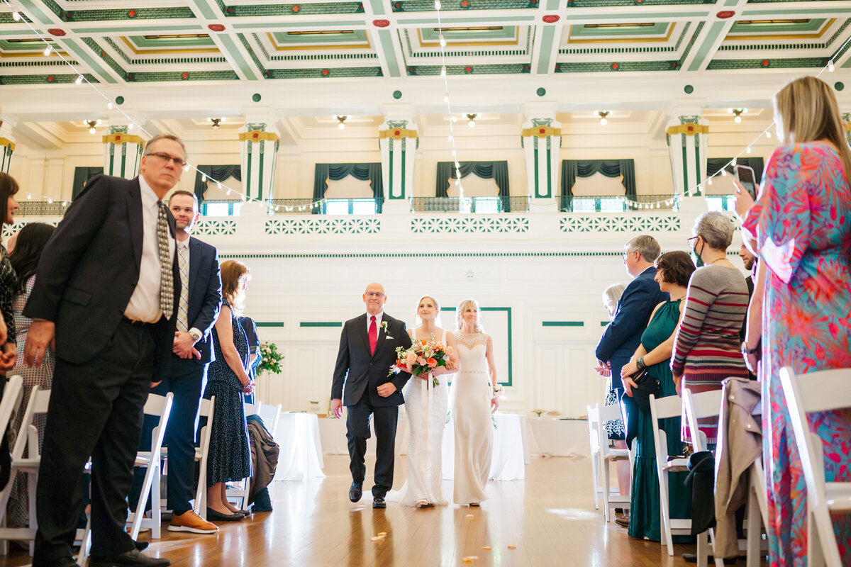 wedding ceremony bride walking down aisle with parents