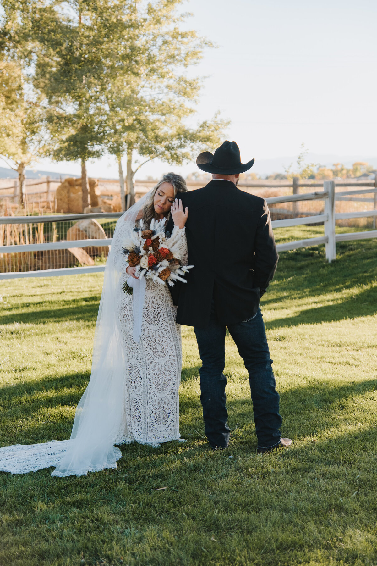 Bride and groom on the lawn, the groom in a cowboy hat