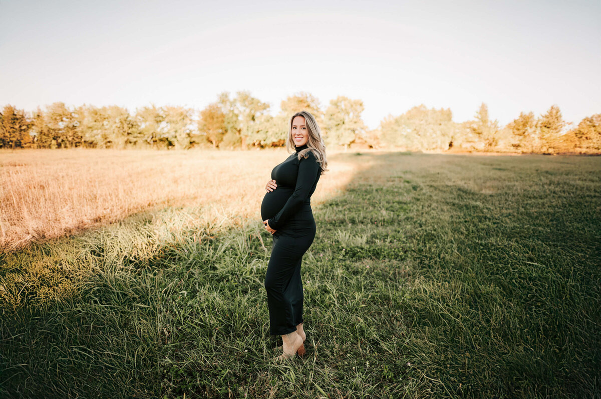 Springfield MO maternity pictures of mom in black dress holding baby bump