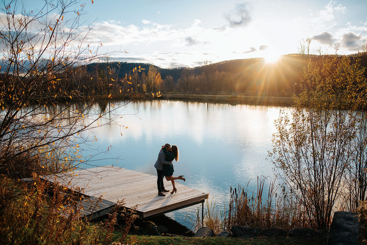 couple kissing on dock ponds at bolton valley vermont