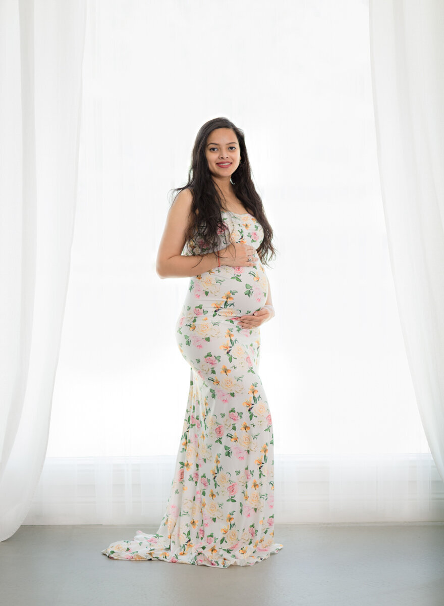 Floral maternity gown in a studio maternity session.