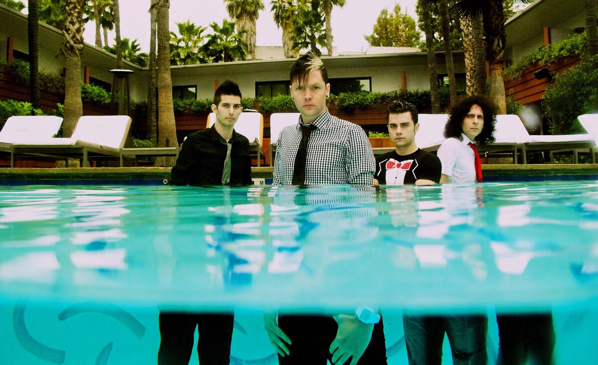 Music group portrait Faber Drive standing in pool