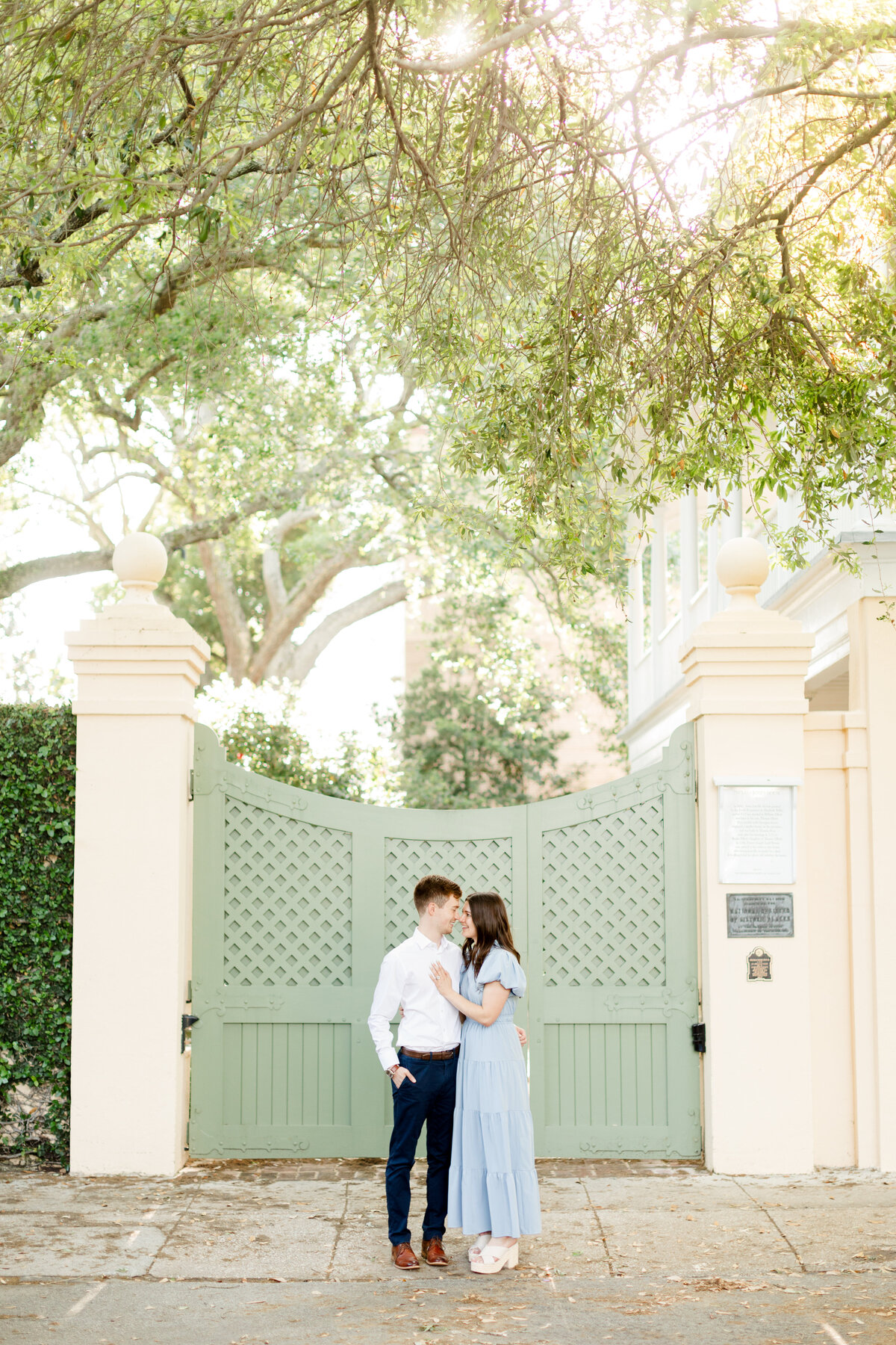 Couple kissing during engagement portraits downtown Charleston, SC