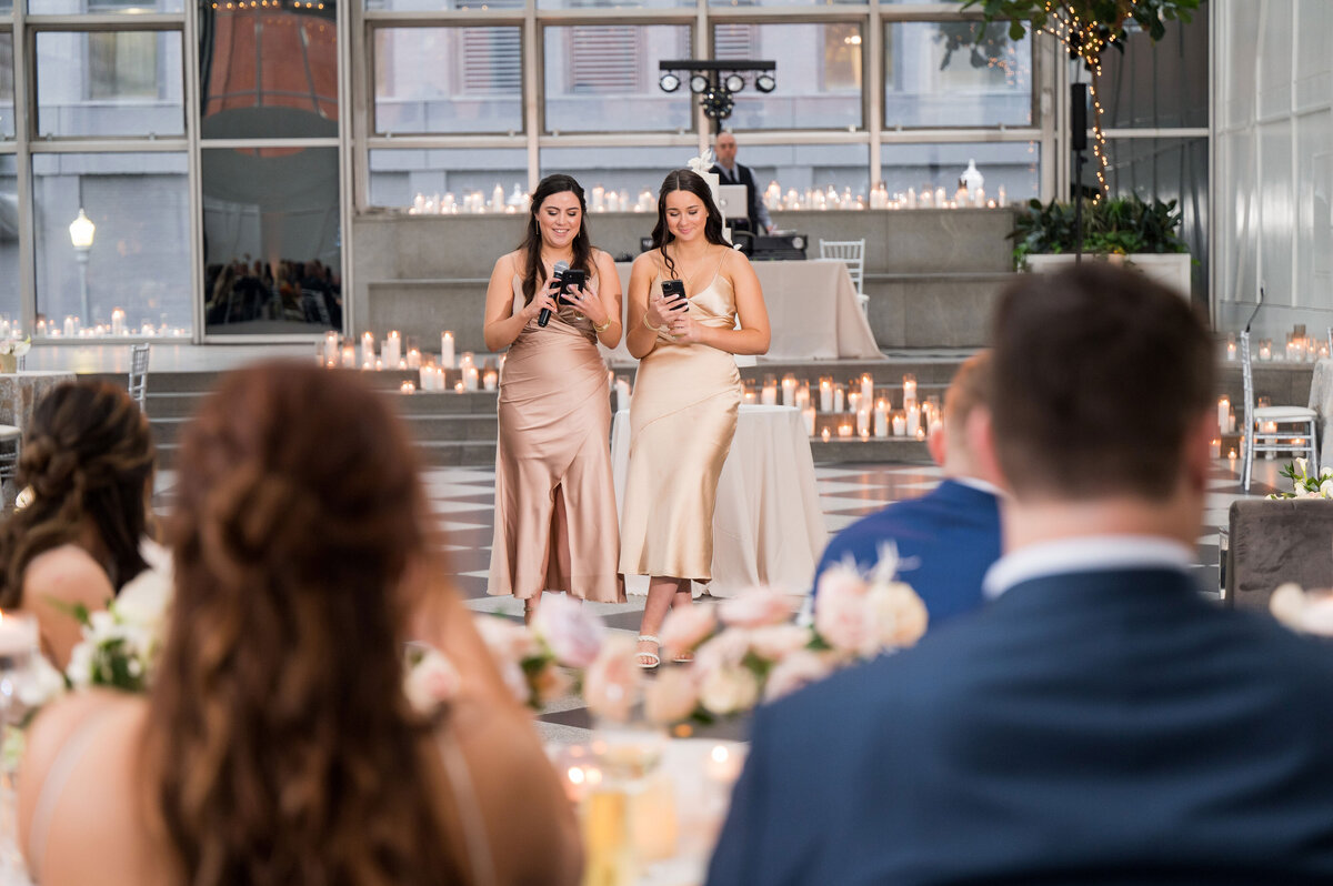 two bridesmaids giving a wedding toast at wintergarden ppf place wedding venue in pittsburgh