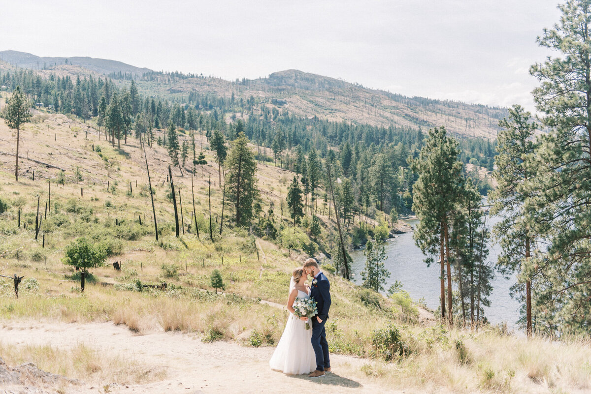 Bride and groom in the mountains captured by Pam Kriangkum Photography, fine art, classic wedding photographer in Edmonton, Alberta. Featured on the Bronte Bride Vendor Guide.