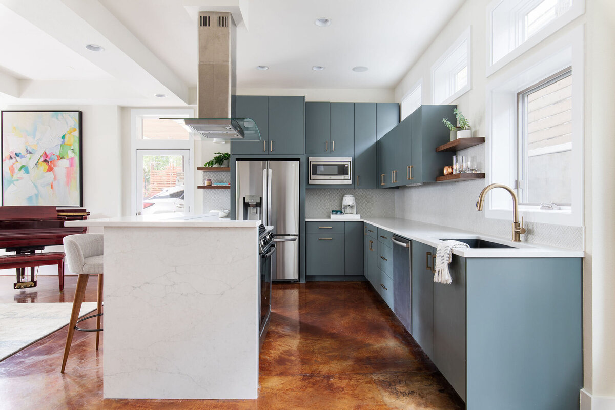 hello-home-Contemporary-Kitchen-Blue-Cabinets-Brass-Hardware-Stainless-Steel-Appliances-Polished-Concrete-Floor-Kitchen-Remodel-quartz-waterfall-island-Austin-TX-6