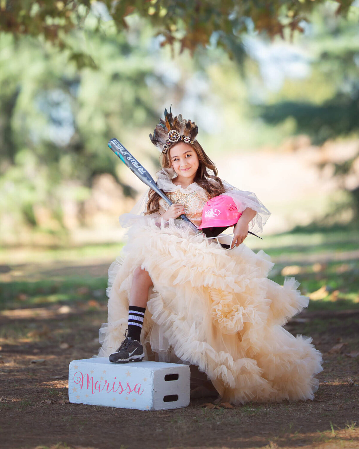 Girl wearing couture gown holding softball bat and hat photographed by Elsie Rose Photography
