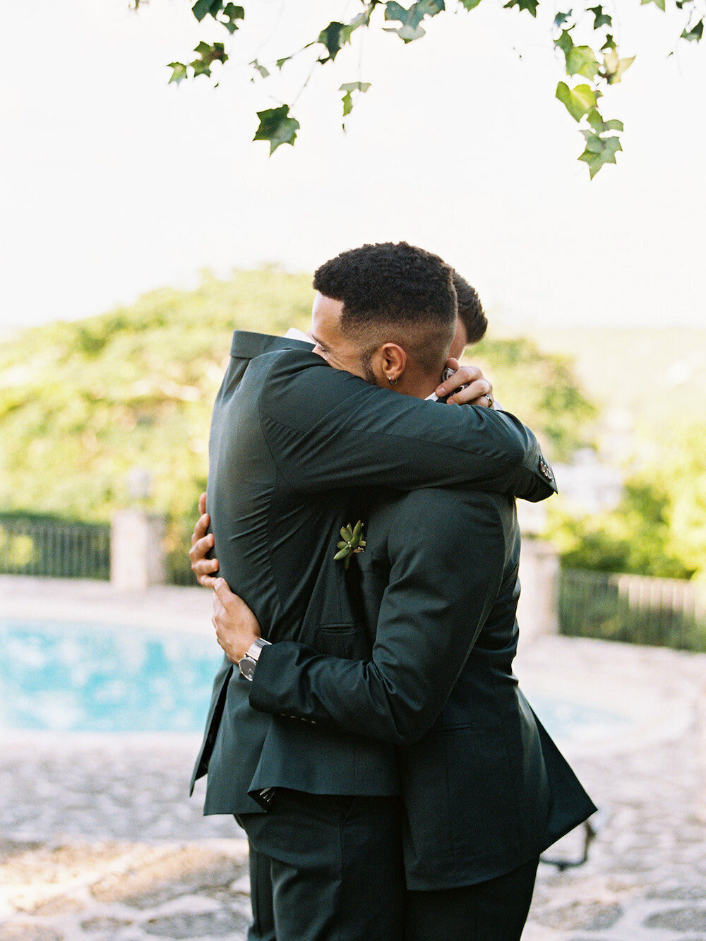 Gay couple hugging at their destination wedding