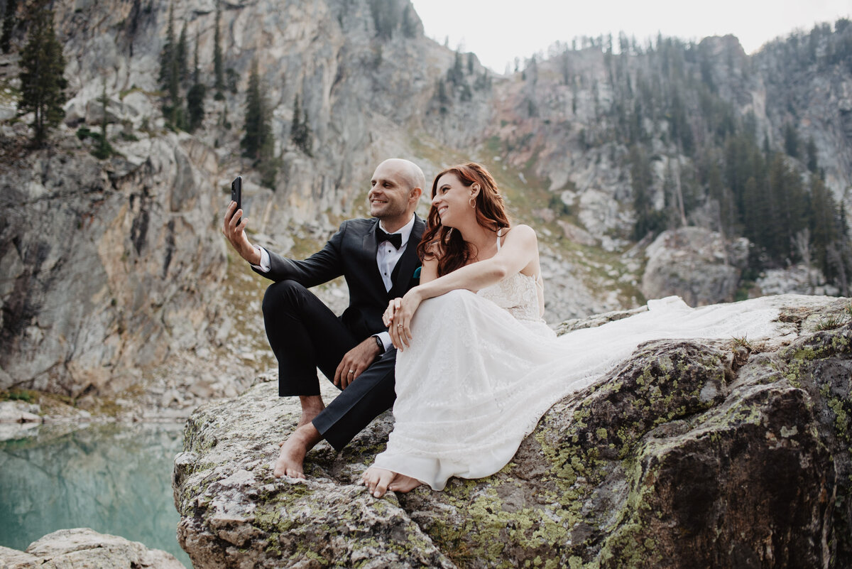 Jackson Hole photographers capture bride and groom taking selfies after intimate elopement ceremony