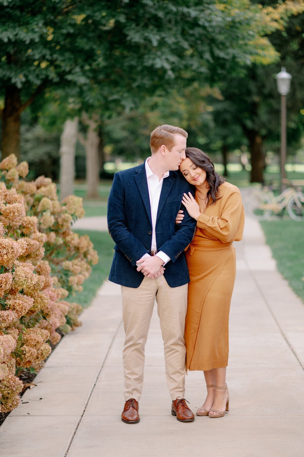 man kissing his fiance on the head