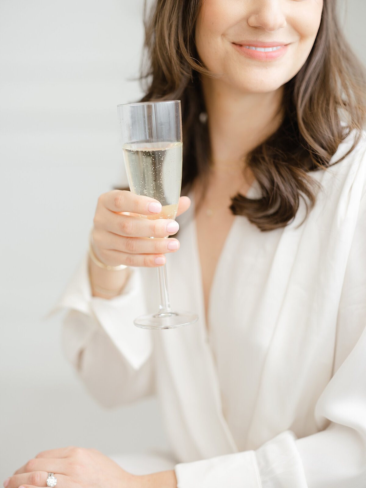Close up detail shot of a DFW business owner holding a glass of champagne for ehr branding headshots.