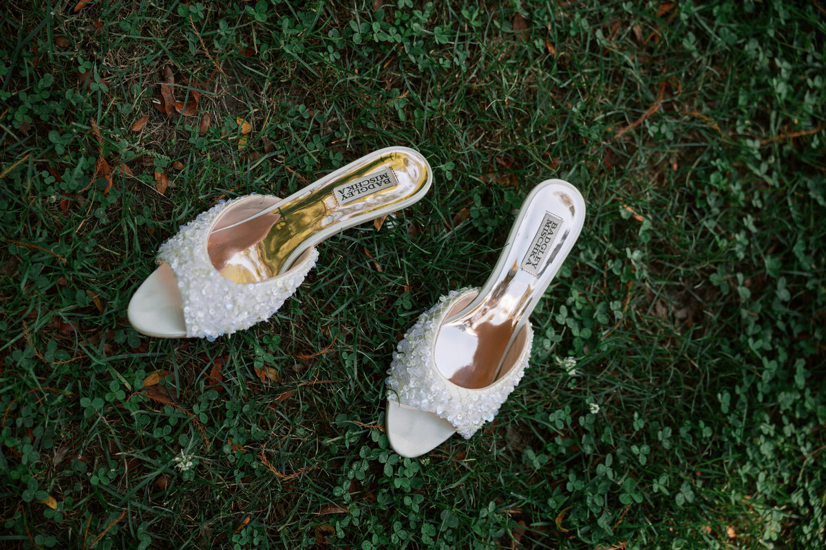 Beaded white bridal heels by Badgley Mischka on grass, detail from Dayton, Ohio wedding, photographed by Philly-based photographer.