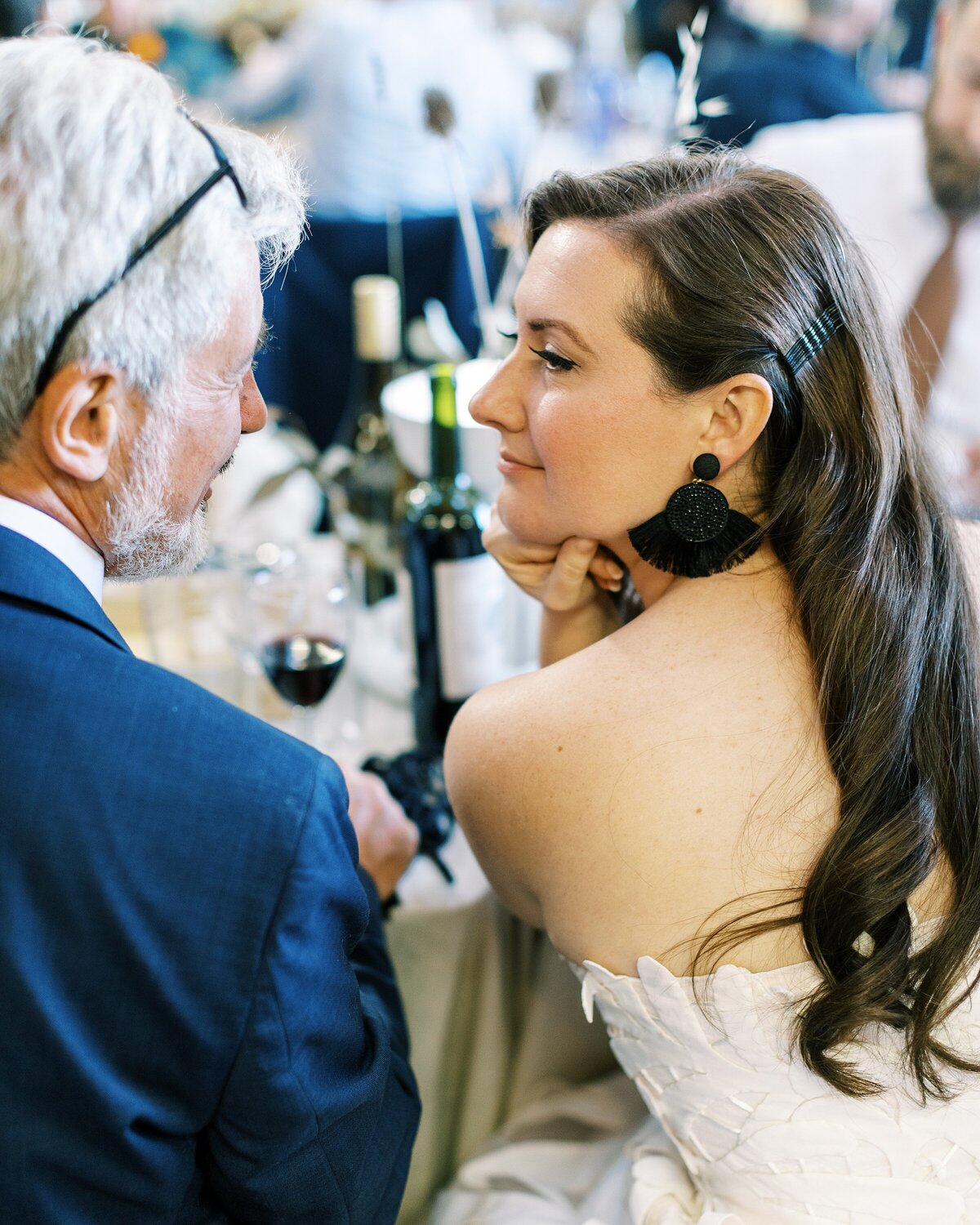 Bride gazes into grooms eyes during dinner at their Sausalito wedding reception