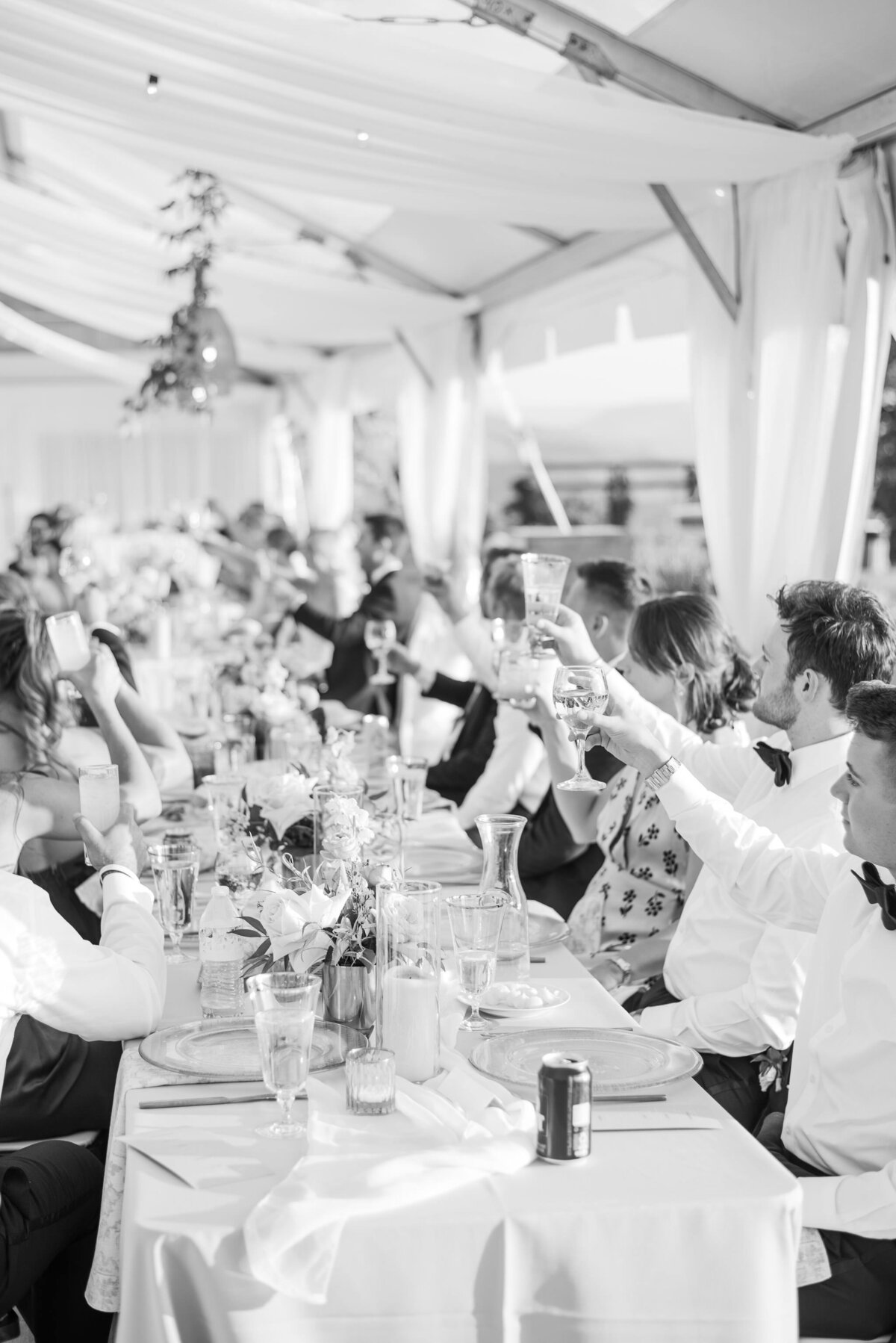 table of guests saying cheers during speeches at a wedding in Steamboat Springs Colorado