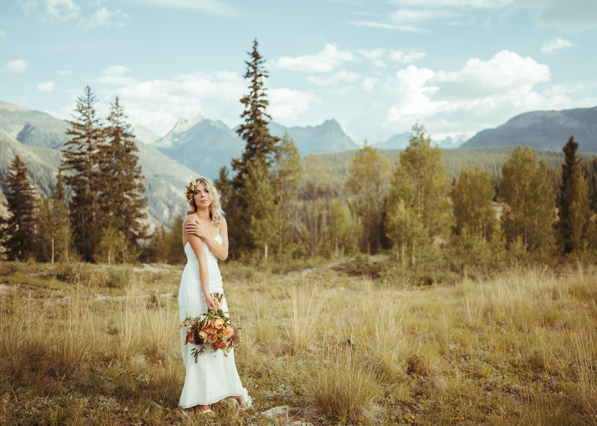 Bride with bouquet  with Ouray mountain landscape behind her