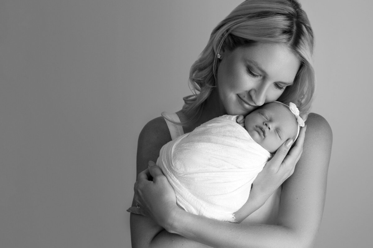 Black white mother holding newborn baby Austin professional family photographer