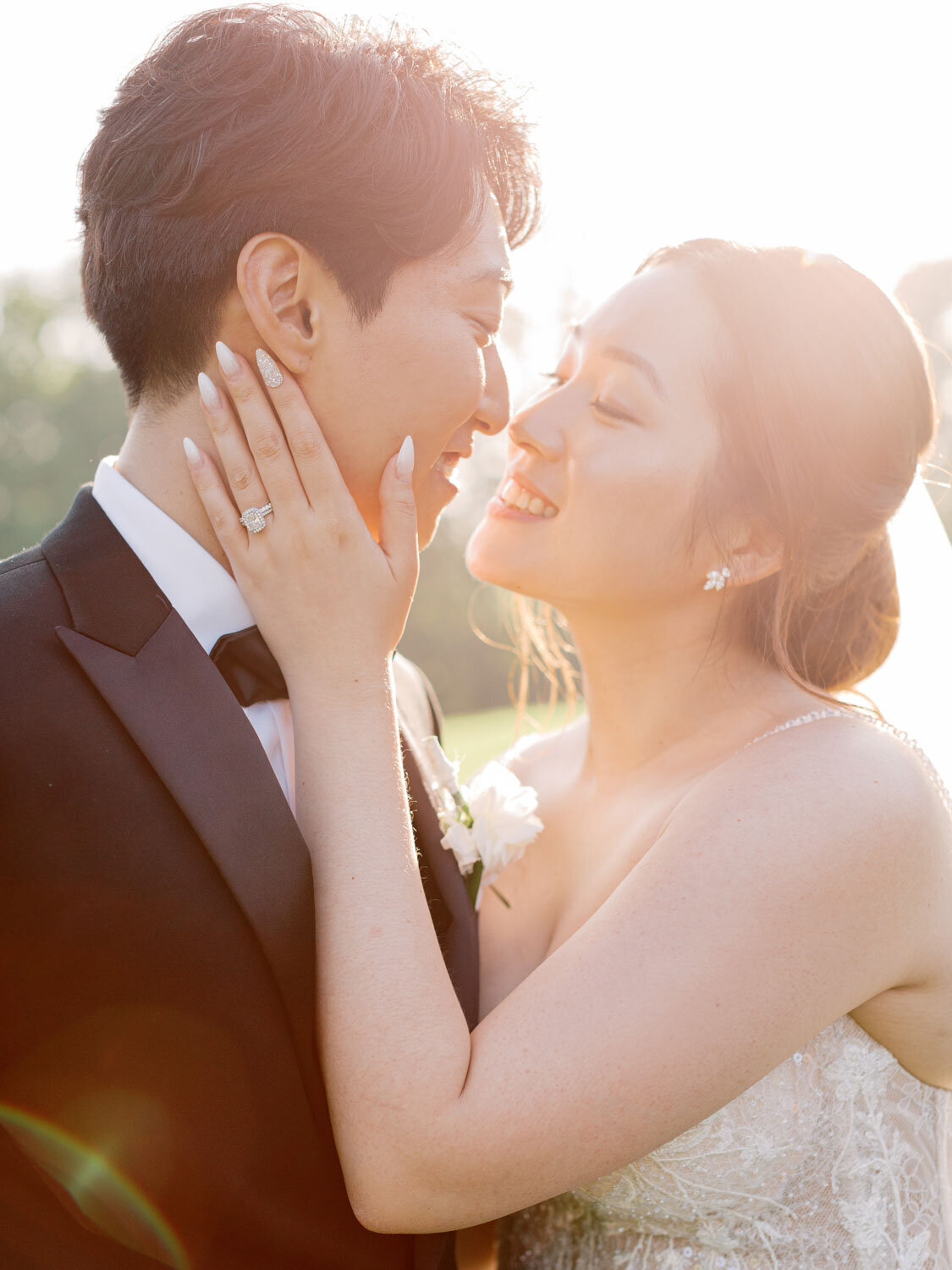 Bride and groom almost kissing in golden sunlight