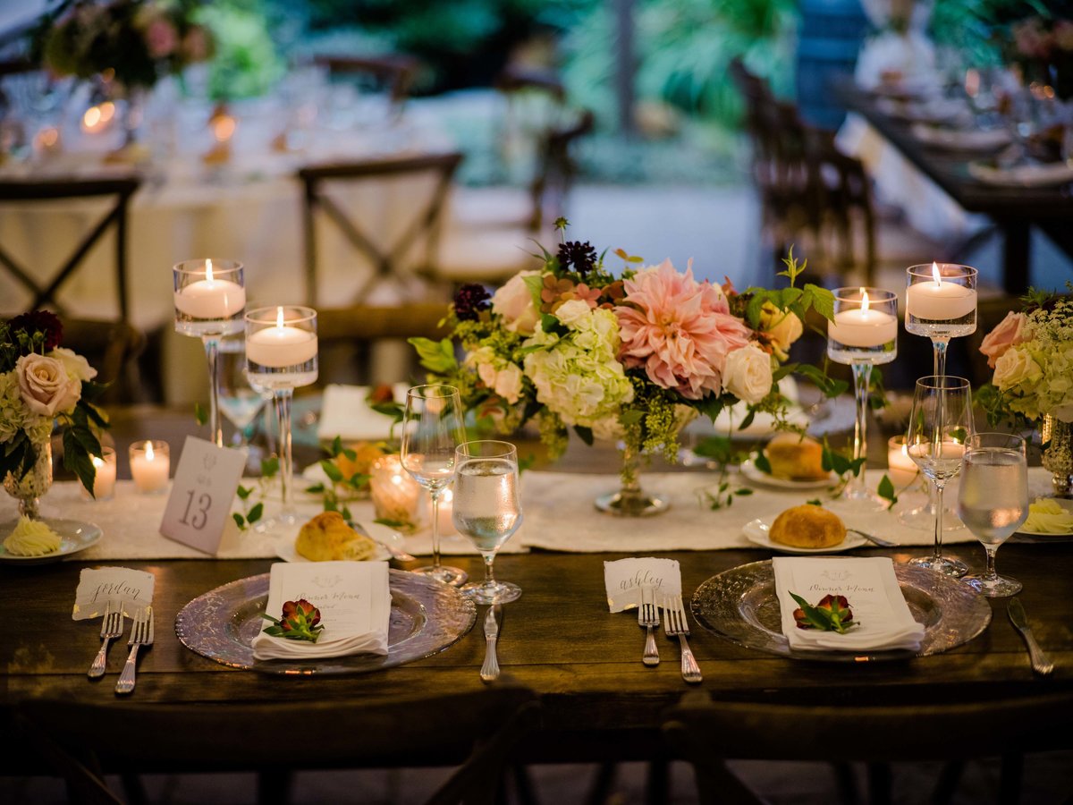 Long candlelite tables in the evening of our garden tent wedding.