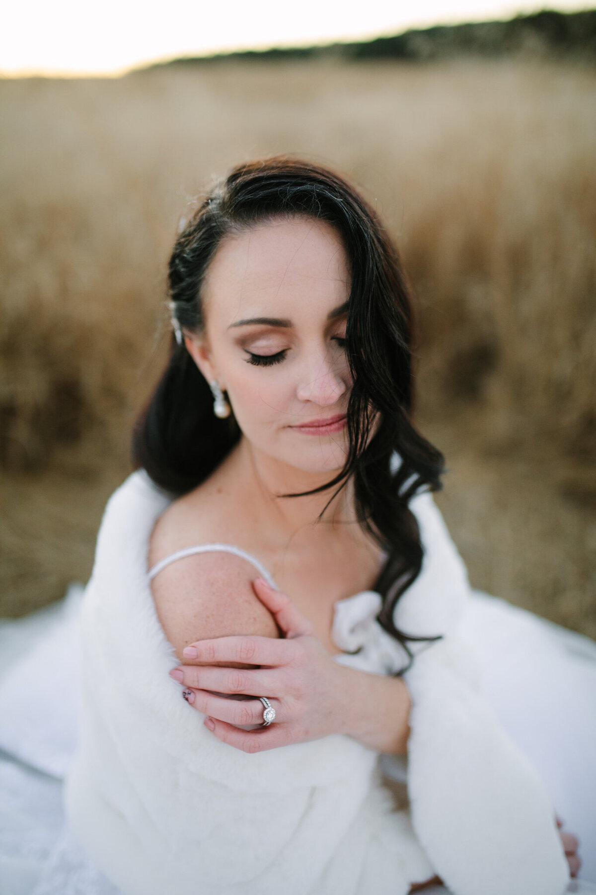 Bridal portrait with the bride closing her eyes, feeling the moment. 
