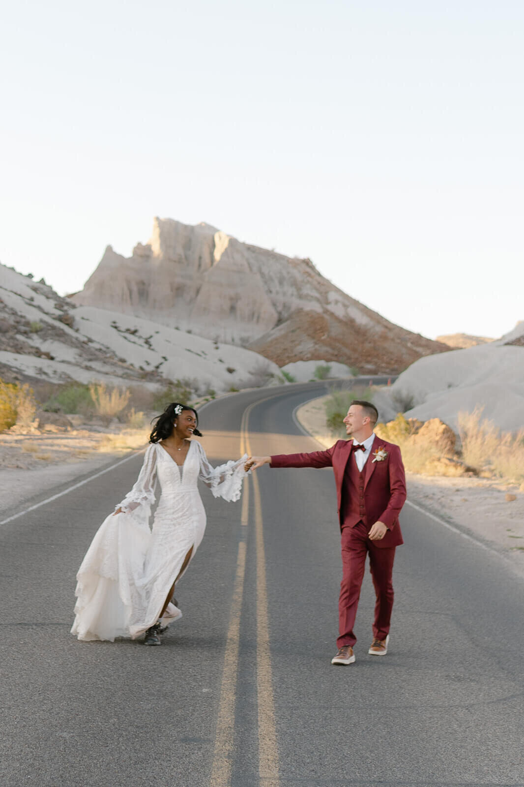 couple runs down desert mountain road