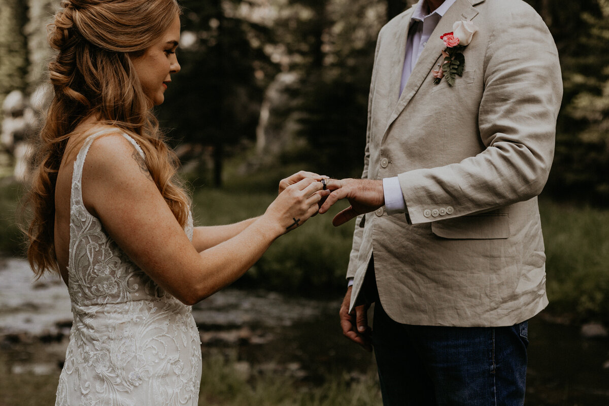 bride and groom exchanging rings during their wedding ceremony