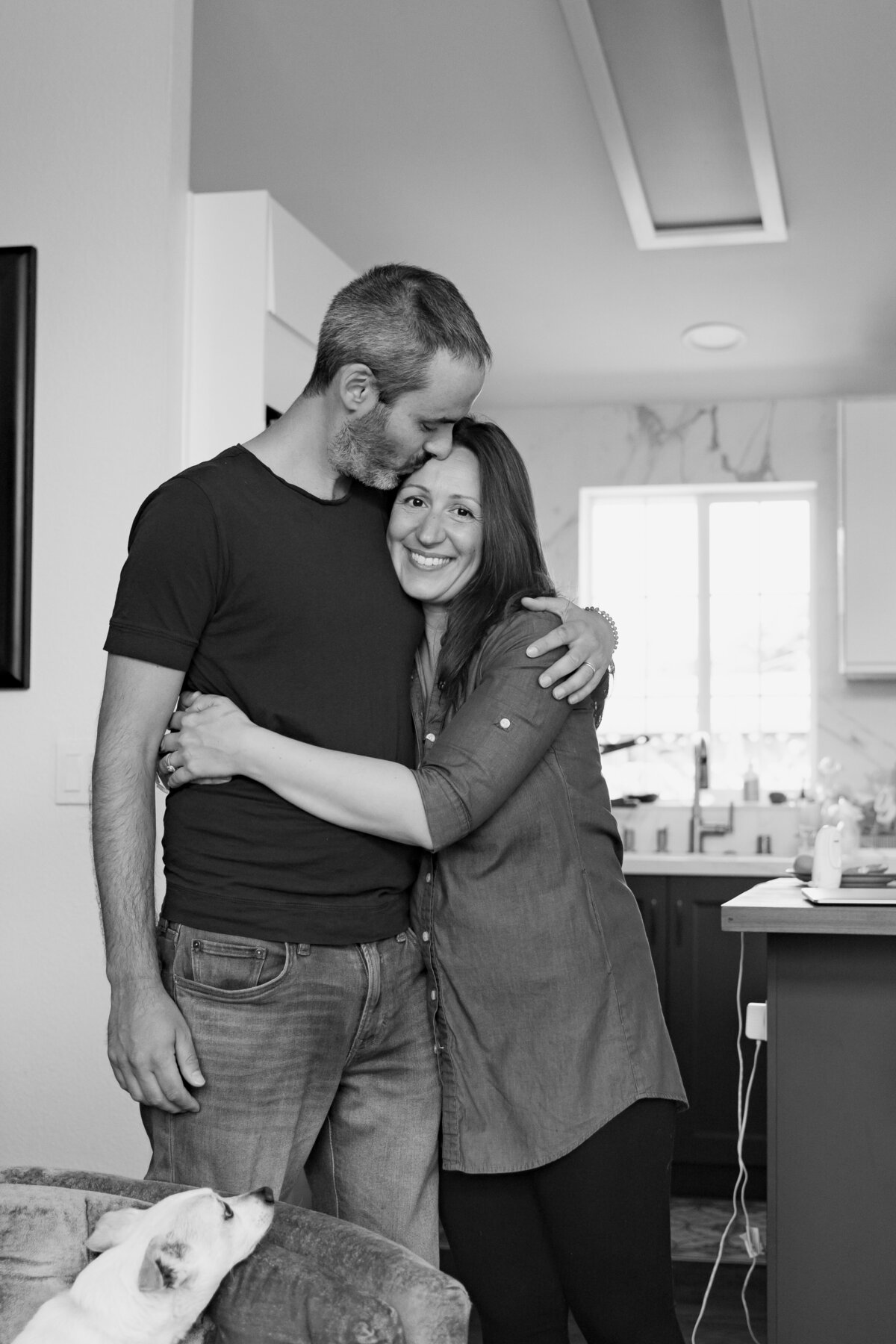 Couple embrace in their kitchen